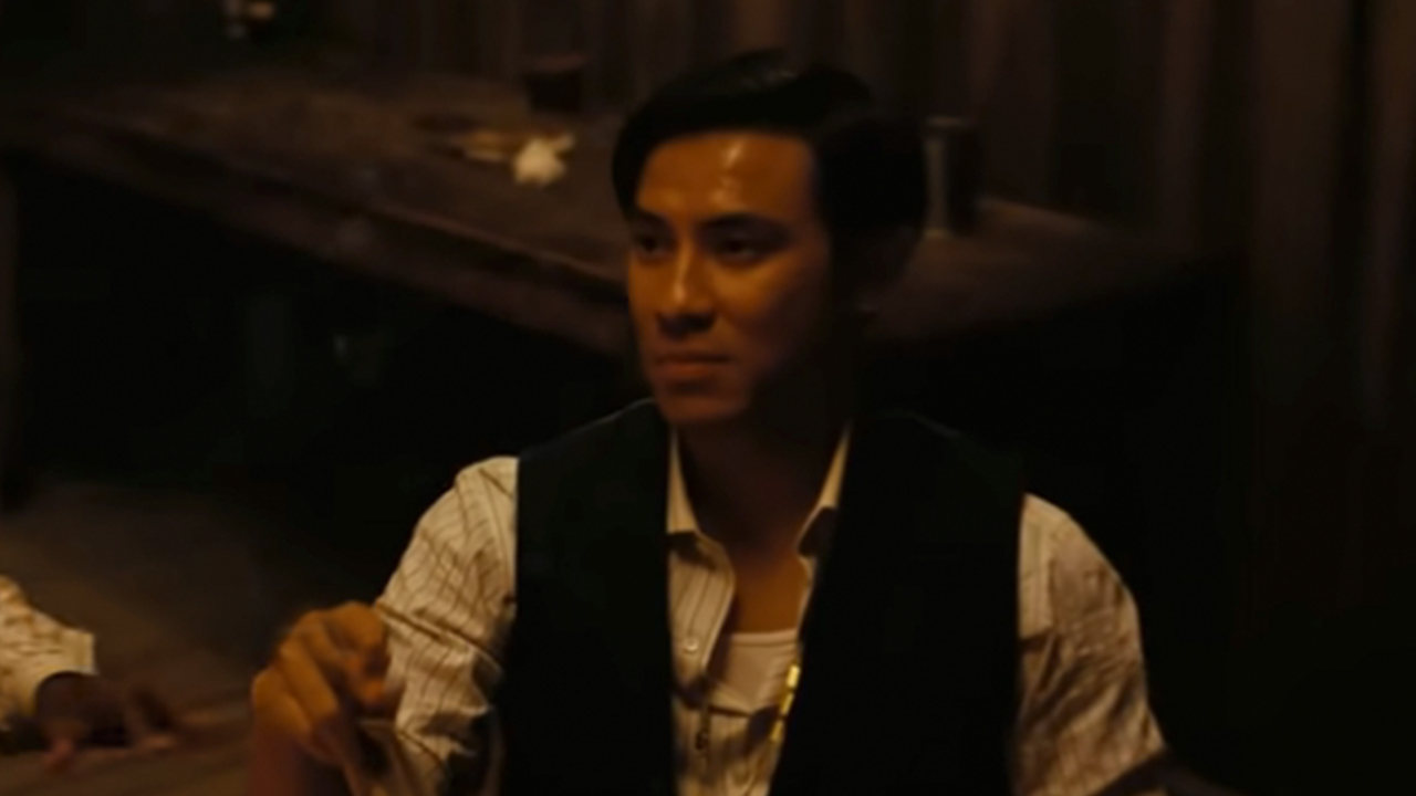 Yao sitting at a table in Sinners