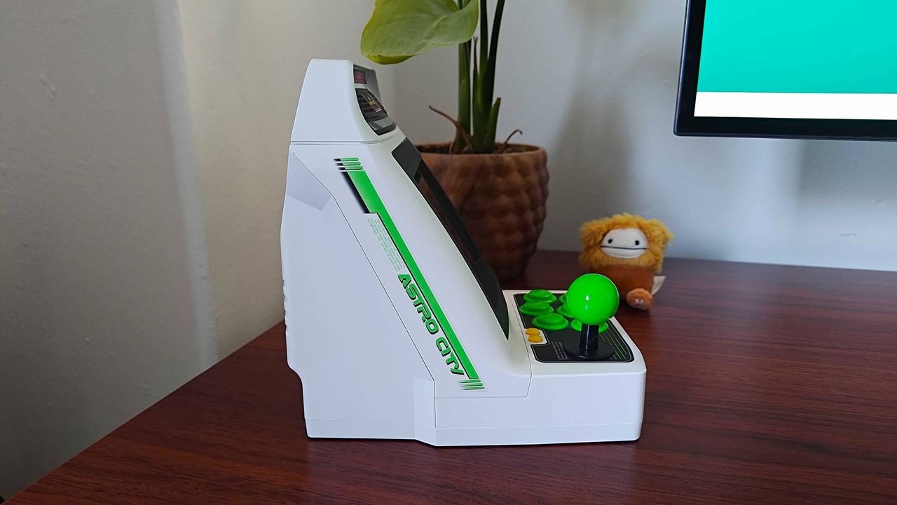 Side view of Sega Astro City Mini arcade machine on woodgrain desk.