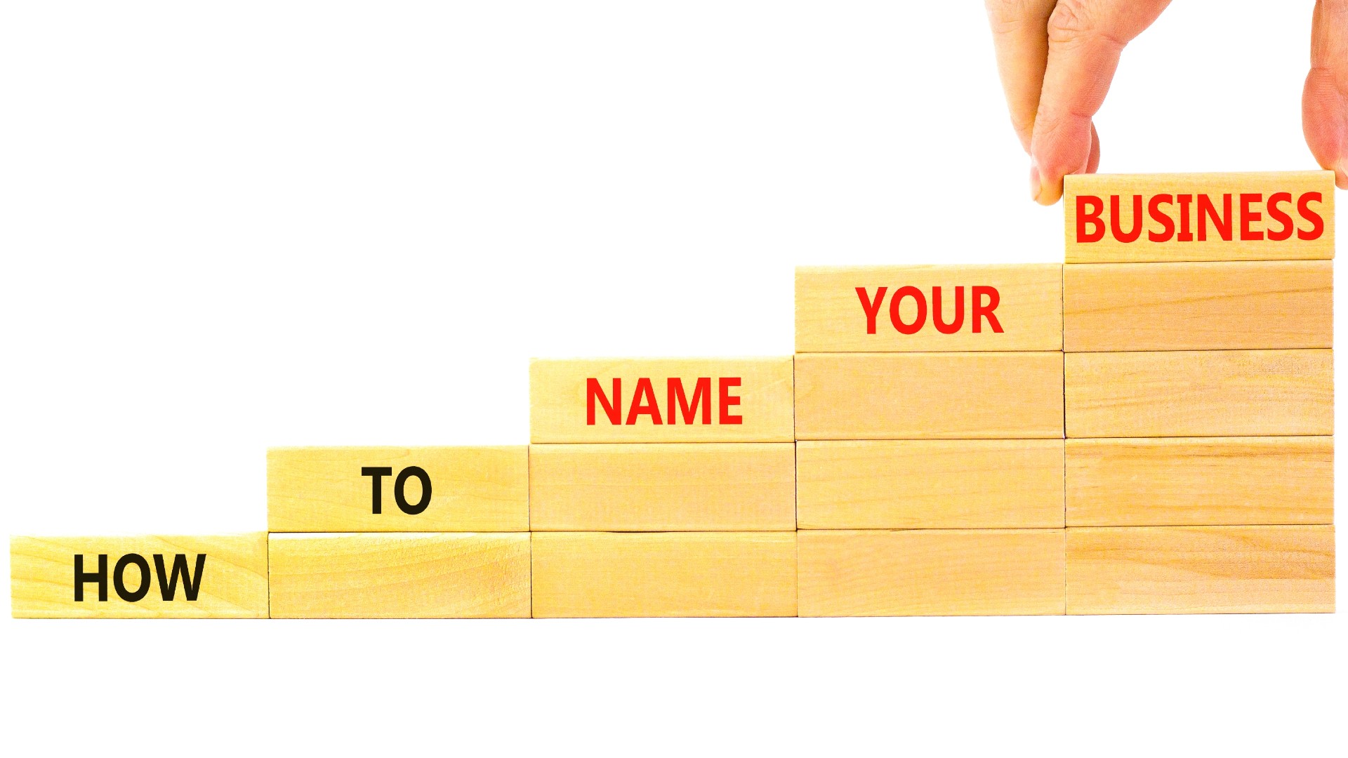 An image of Jenga blocks with the text how to name your business 