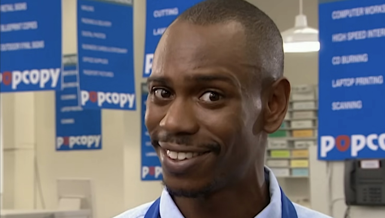 Dave Chappelle smiling into the camera for PopCopy sketch on Chappelle's Show