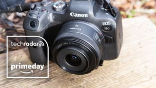 Canon RF 16mm F2.8 IS STM lens attached to an EOS R6 camera, on a wooden bench