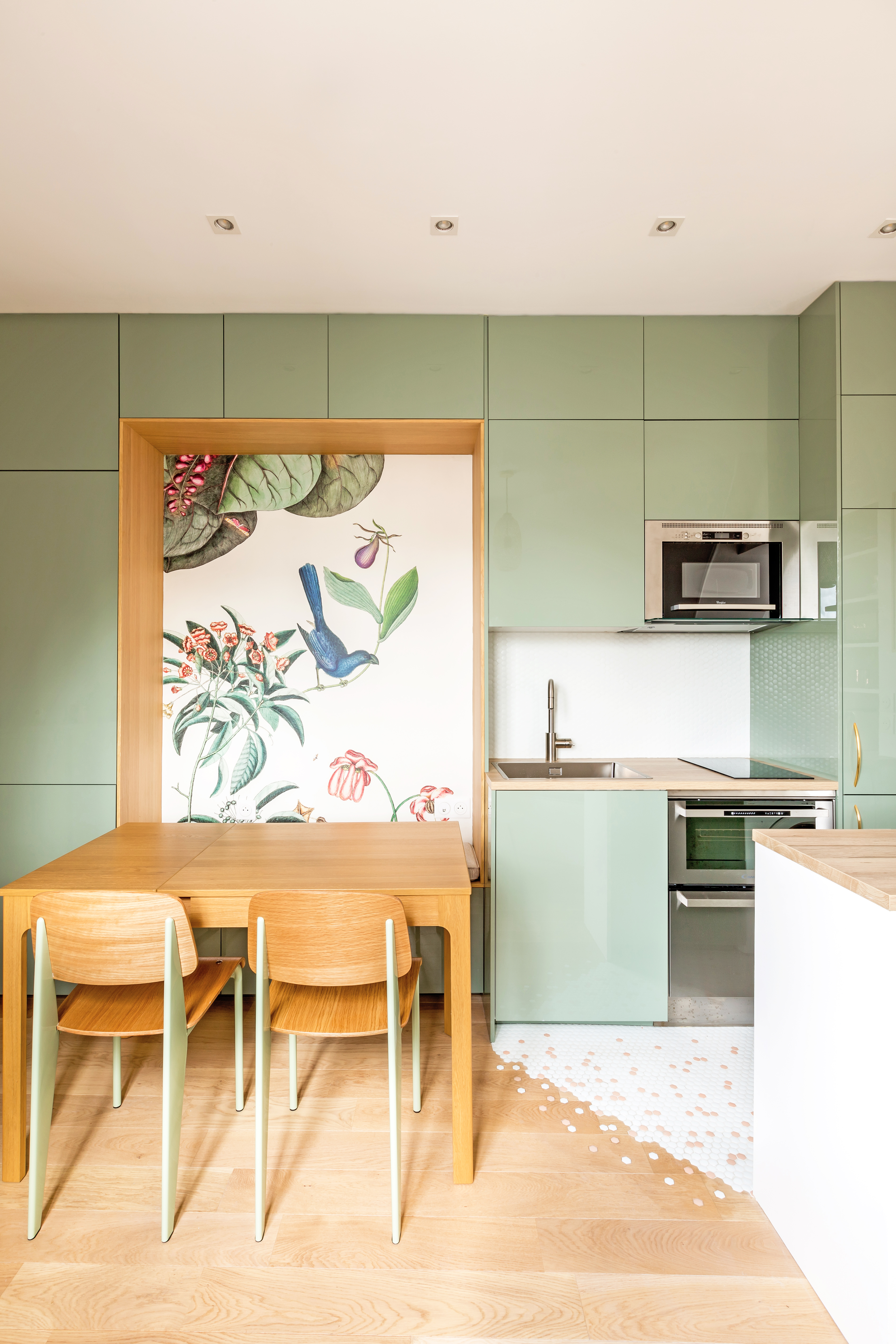 A kitchen in green, with tiny mosaic tiles used only for the kitchen