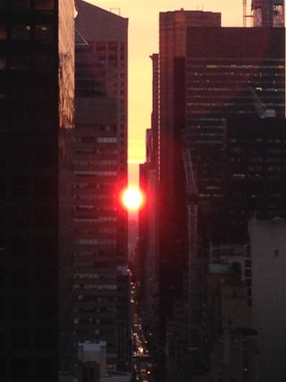 Pamela Chasek snapped this photo of the setting sun on July 11, 2013, a day before the full Manhattanhenge sunset. Chasek took the photo with her iPhone from a rooftop of a building near the intersection of 56th Street and Second Avenue.
