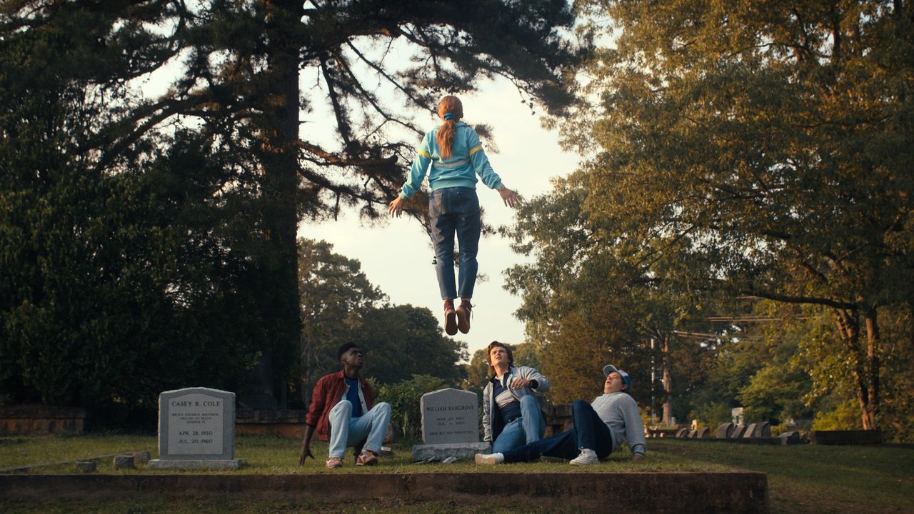 Sadie Sink as Max levitating above a grave in Stranger Things