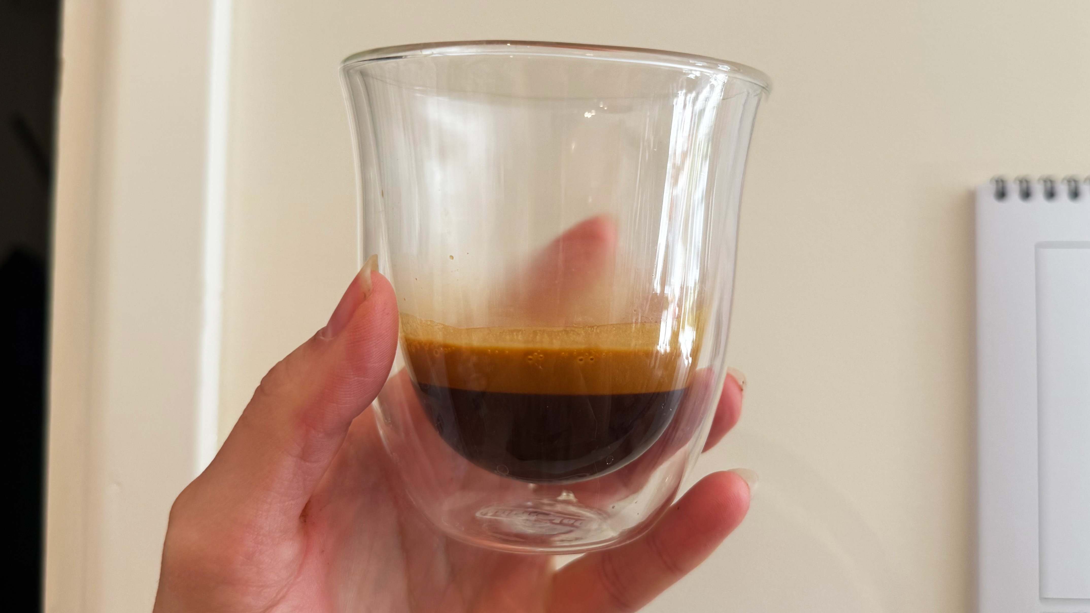 a photograph of an espresso shot pulled on the breville bambino plus in a small glass