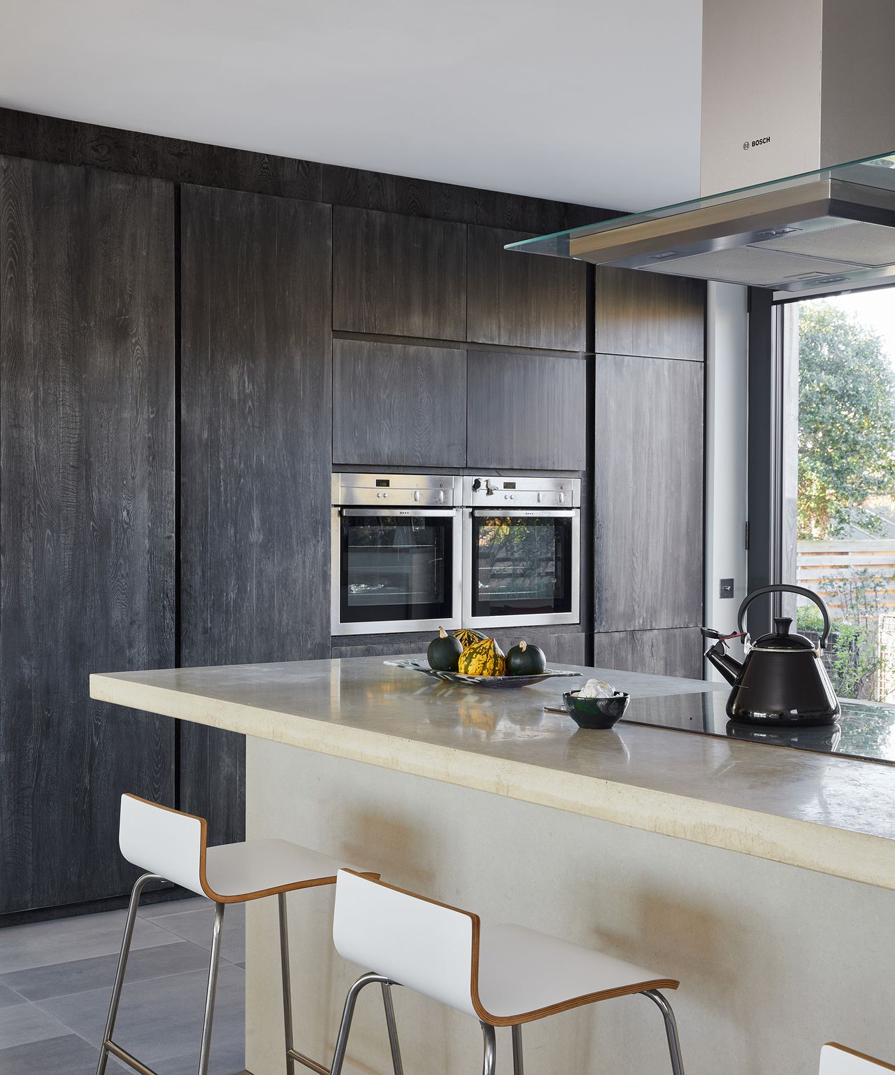 Built in dark oak cabinetry with double oven