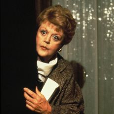 angela lansbury peering around a corner in a still from murder she wrote