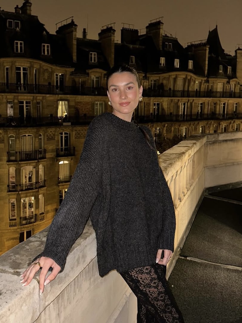 Brooke Puth wearing a gray oversize sweater and lace pants.