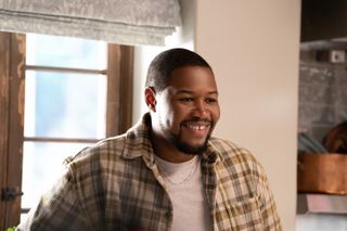 Luke Tennie as Sean, standing in front of a kitchen window, in 'Shrinking'