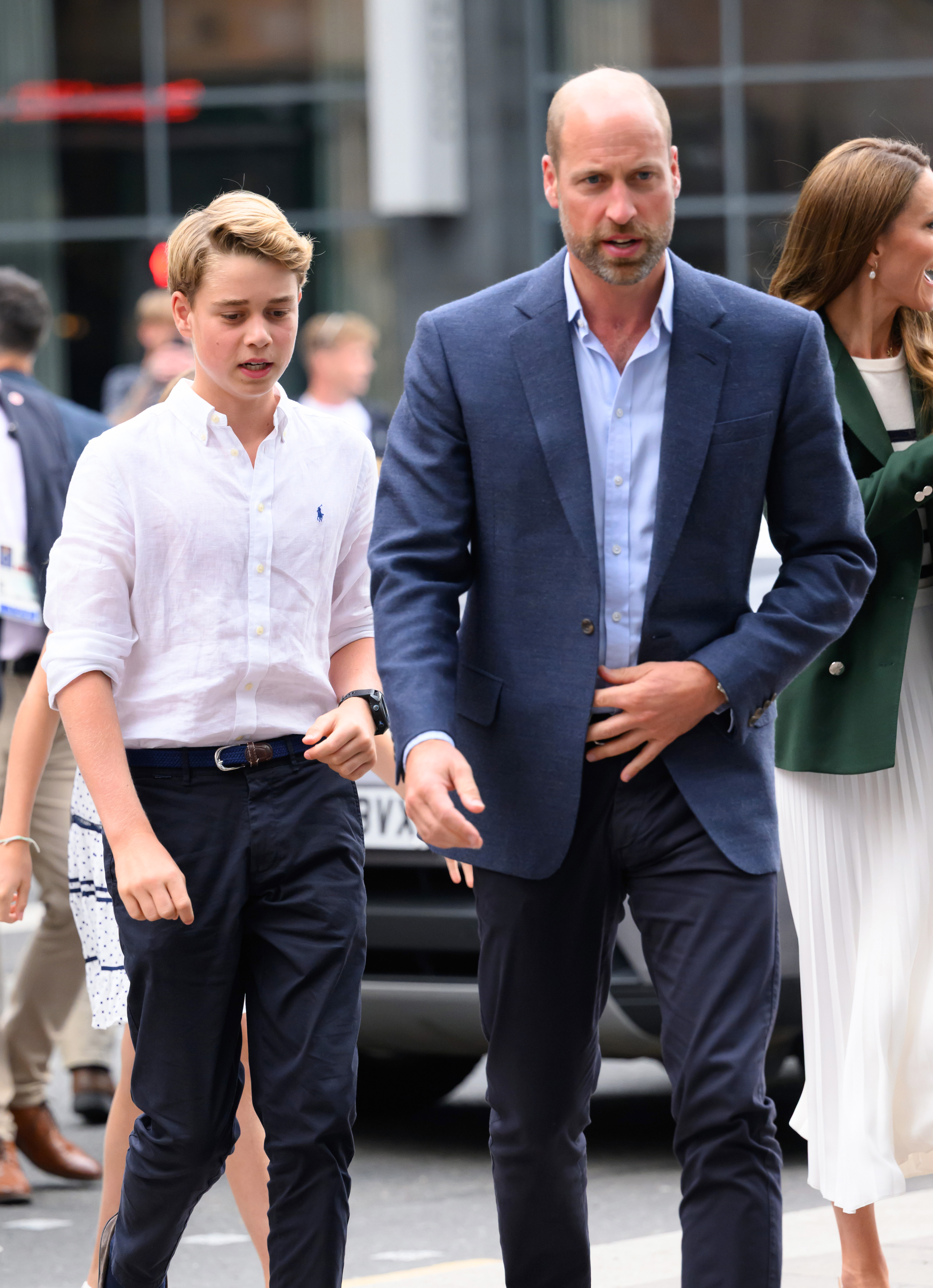 Prince George walking behind Prince William at the Commonwealth Games