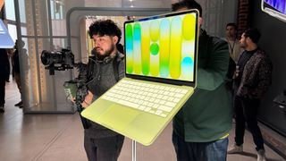 macbook neo on display at apple event in yellow and blue