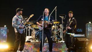 Jonny Buckland, Chris Martin and Guy Berryman of Coldplay perform as the band headline the Pyramid stage during day four of Glastonbury Festival 2024 