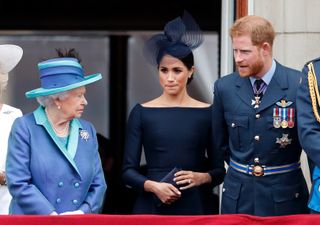 LONDON, UNITED KINGDOM - JULY 10: (EMBARGOED FOR PUBLICATION IN UK NEWSPAPERS UNTIL 24 HOURS AFTER CREATE DATE AND TIME) Queen Elizabeth II, Meghan, Duchess of Sussex and Prince Harry, Duke of Sussex watch a flypast to mark the centenary of the Royal Air Force from the balcony of Buckingham Palace on July 10, 2018 in London, England. The 100th birthday of the RAF, which was founded on on 1 April 1918, was marked with a centenary parade with the presentation of a new Queen's Colour and flypast of 100 aircraft over Buckingham Palace. (Photo by Max Mumby/Indigo/Getty Images)