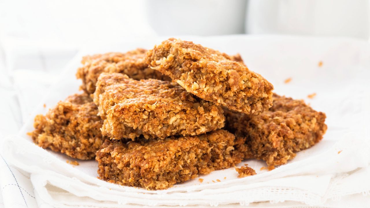 Treacle flapjacks stacked onto a white cloth