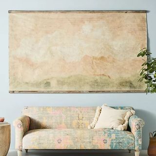 A living room with wall tapestry