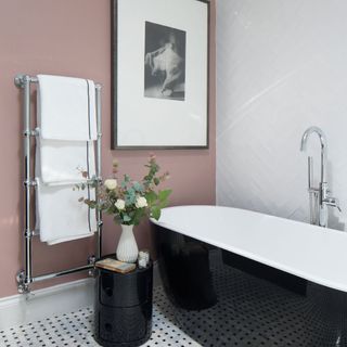 bathroom with bathtub and photoframe on wall