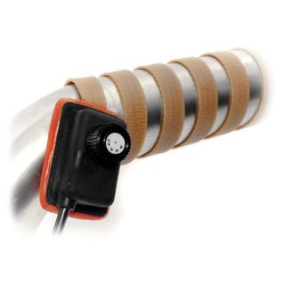 A metal pipes with brown heat tape wrapped around it, a black thermostat ocntrol beside it . 