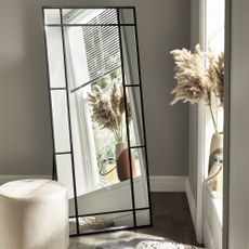 Full length window mirror in bedroom