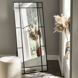 Full length window mirror in bedroom