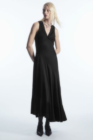 woman wearing black satin midi dress from the cos sale
