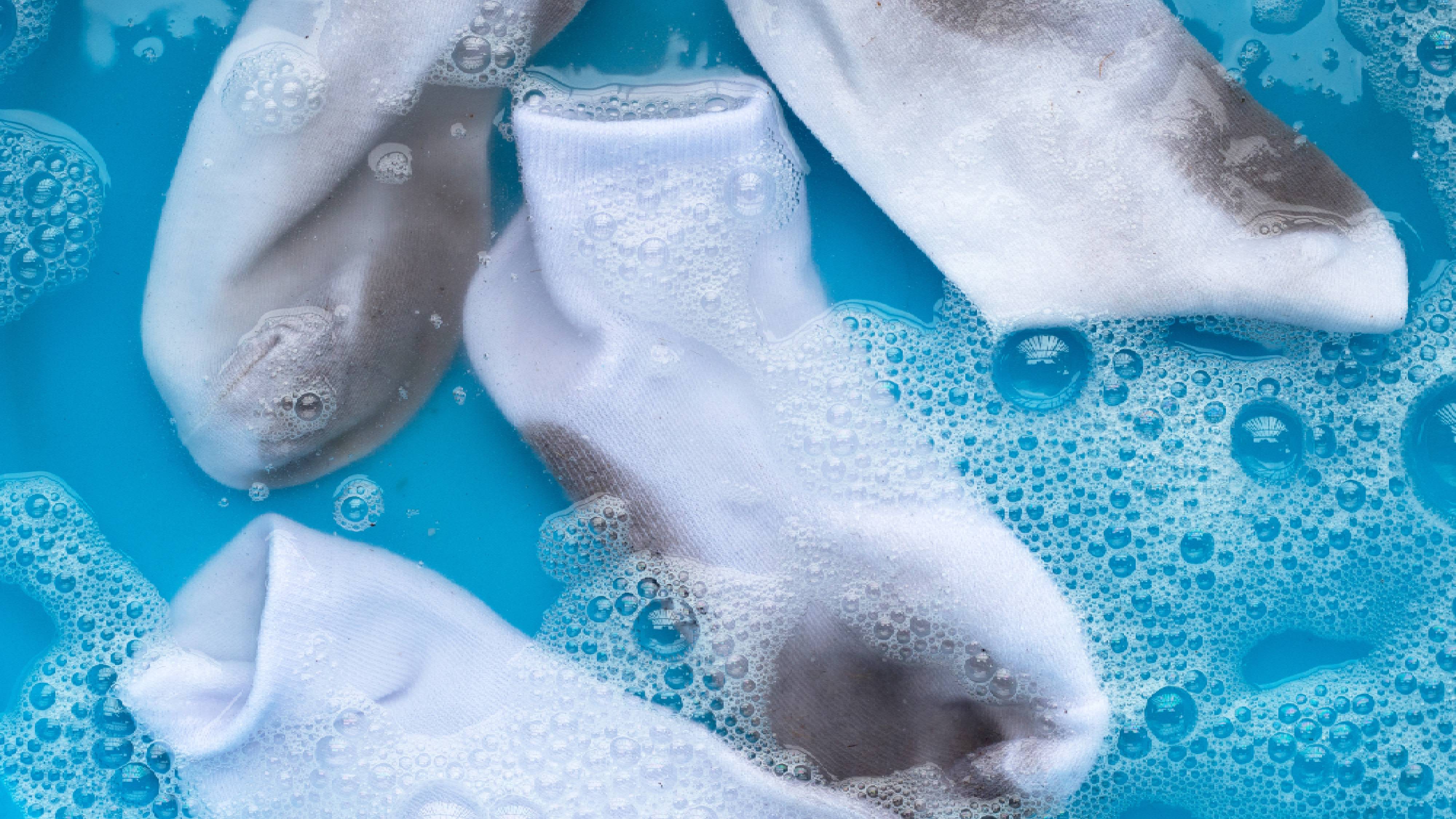 Discolored white socks being pre-treated
