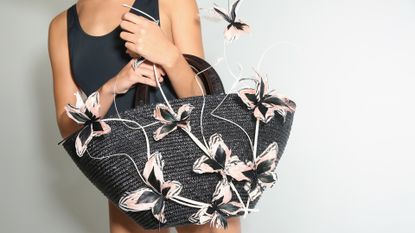 A model poses on the runway with a beach bag at the Eugenia Kim Presentation during New York Fashion Week: The Shows at Pier 59 on September 9, 2017 in New York City