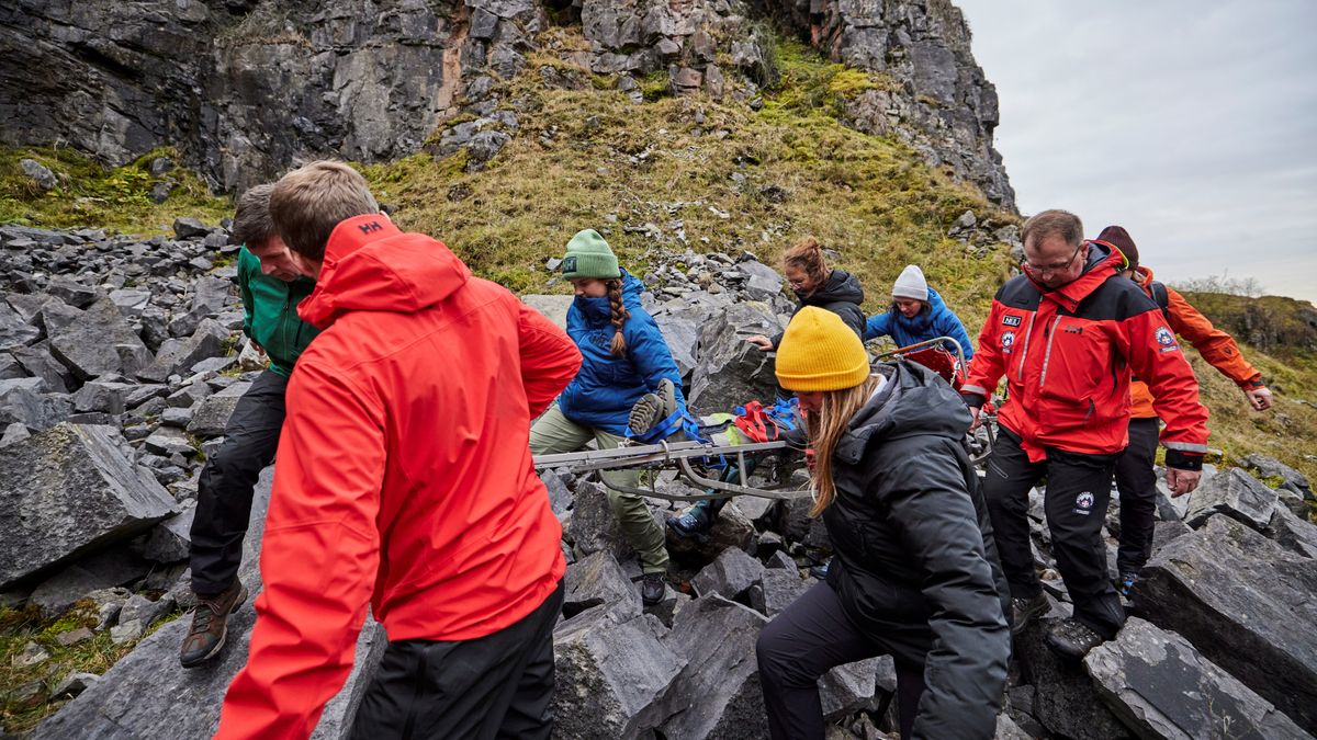 Mountain rescue loads up a stretcher in a training exercise