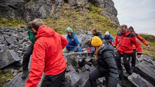 Mountain rescue loads up a stretcher in a training exercise