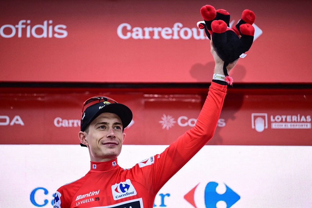 Team Visma-Lease a bike's Danish rider Jonas Vingegaard, wearing the overall leader's red jersey, celebrates on the podium after winning the second stage of the Vuelta a Espana, a 159,6 km race between Alba and Limone Piemonte, in Italy's Piemonte region, on August 24, 2025. (Photo by Marco BERTORELLO / AFP)