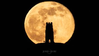 The Full Snow Moon of February 2023 rises over Glastonbury Tor, a hill and monument in Somerset, U.K. linked with the mythology of King Arthur.