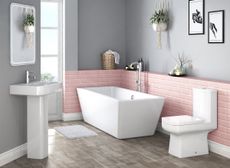 bathroom suite with angular lines, pink metro tiles and grey walls