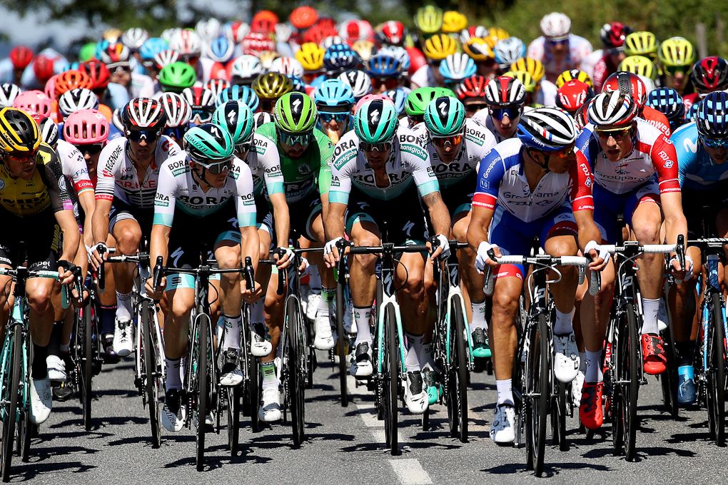 The Tour de France peloton is spread across the road