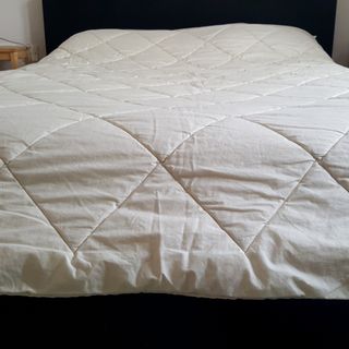 The Woolroom Deluxe Washable Wool Duvet being tested on a bed