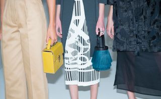 Models carring handy Handbags in Fashion show.
