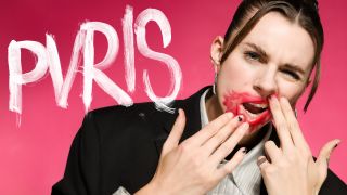 Lyndsey Gunnulfsen of the band Pvris poses for a portrait in smeared red lipstick and a grimace on her face