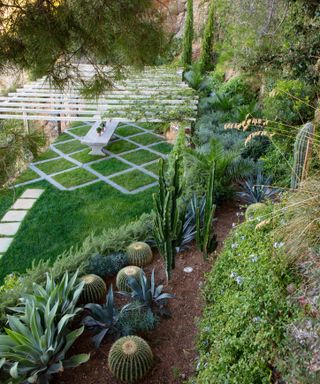 pergola over grass rhombic parterre on terraced garden with mediterranean plants