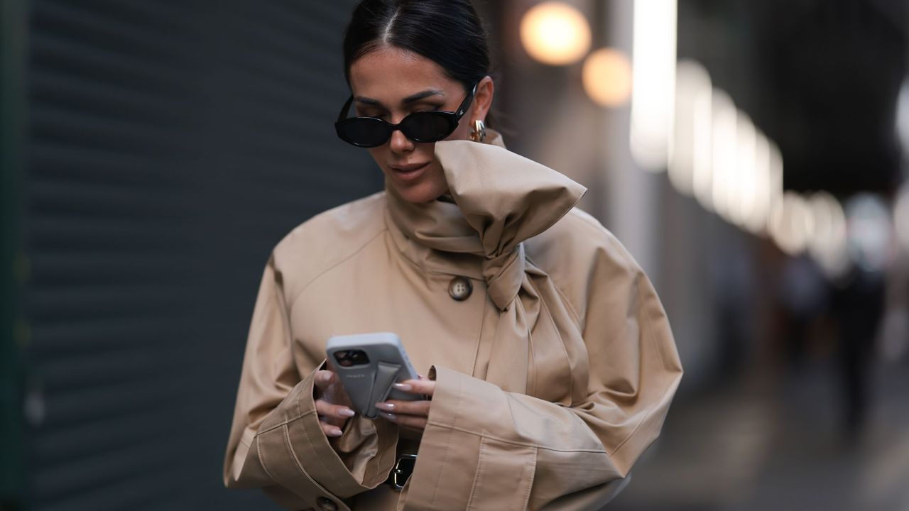 Woman using Rhode phone case with chrome nails 