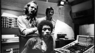 Jimi Hendrix (1942 - 1970) (seated), South African-born American music producer and engineer Eddie Kramer (standing left) and studio manager Jim Marron as they pose in the control room of Hendrix's then still under construction Electric Lady Studio, New York, New York, June 17, 1970.