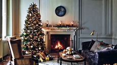 A christmas living room with roaring log fire and chtistmas tree
