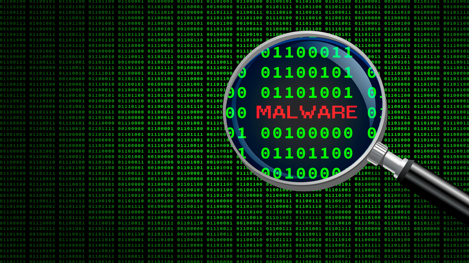 Magnifying glass enlarging the word 'malware' in computer machine code