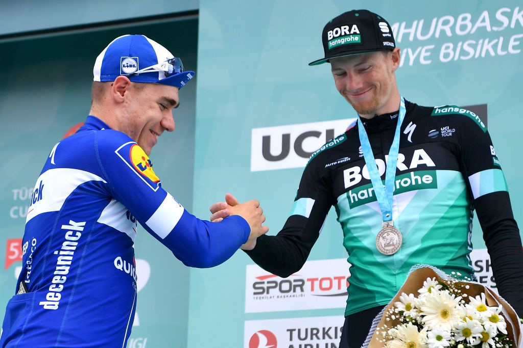 Fabio Jakobsen and Sam Bennett sake hands on the podium