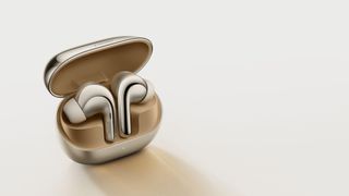 Xiaomi Buds 4 Pro earbuds in golden and chrome case