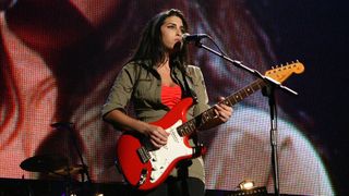 Amy Winehouse performs on stage as part of "The Miller Strat Pack" concert, at Wembley Arena on September 24, 2004 in London. The event pays homage to the Fender Stratocaster, is in aid of Nordoff-Robbins Music Therapy, and celebrates 50 years of the iconic guitar.