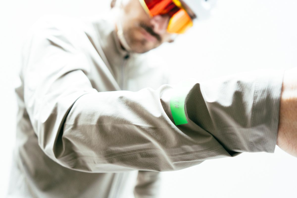 The foreaem of an off-white waterproof cycling jacket