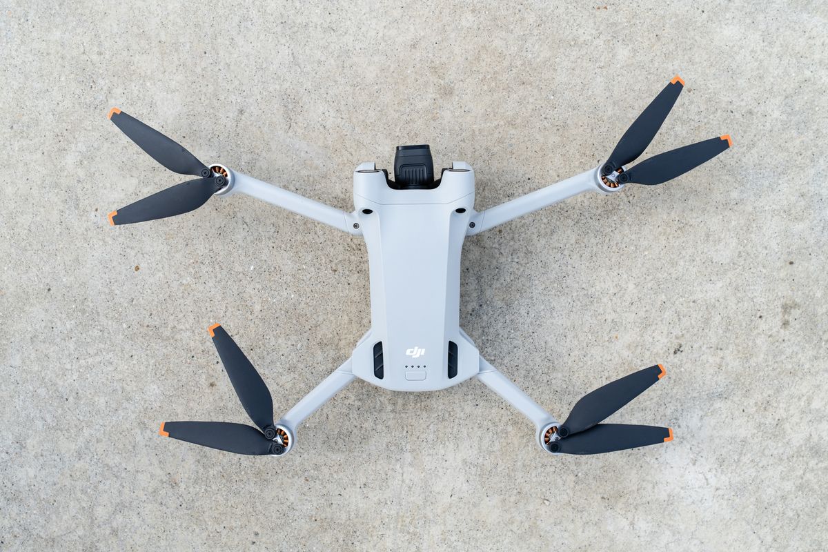 The DJI Mini 3 Pro drone resting on the ground