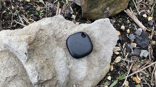 A Samsung Galaxy SmartTag Plus on a rock