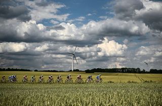 The pack of riders cycles past fields during the 3rd stage of the 109th edition of the Tour de France cycling race 182 km between Vejle and Sonderborg in Denmark on July 3 2022 Photo by Marco BERTORELLO AFP Photo by MARCO BERTORELLOAFP via Getty Images