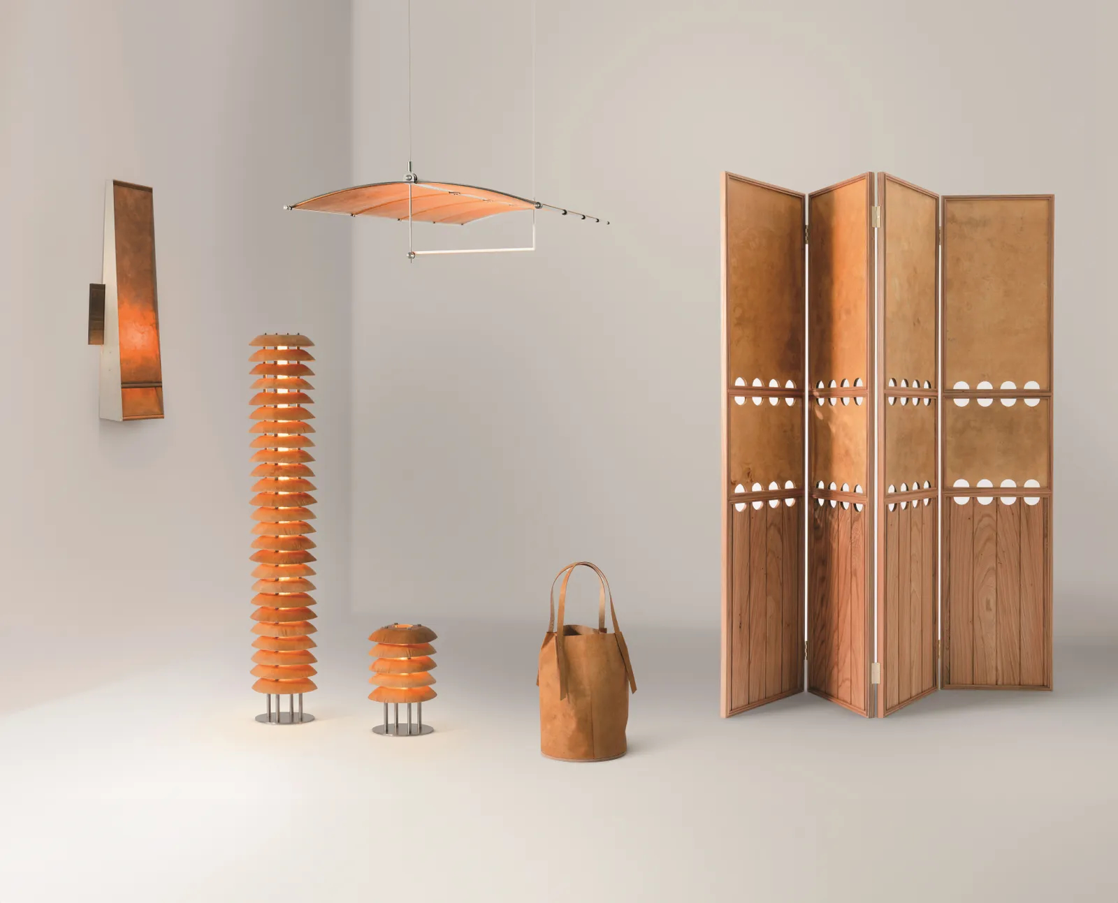 A design showroom installation of wooden furniture, including standing and pendant lamps, a wooden bag, a speared, and a back-lit sconce.