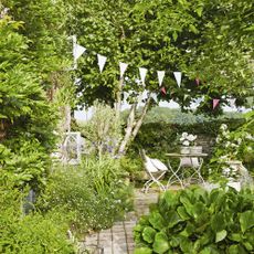 garden with greenery and shrubs and white bunting