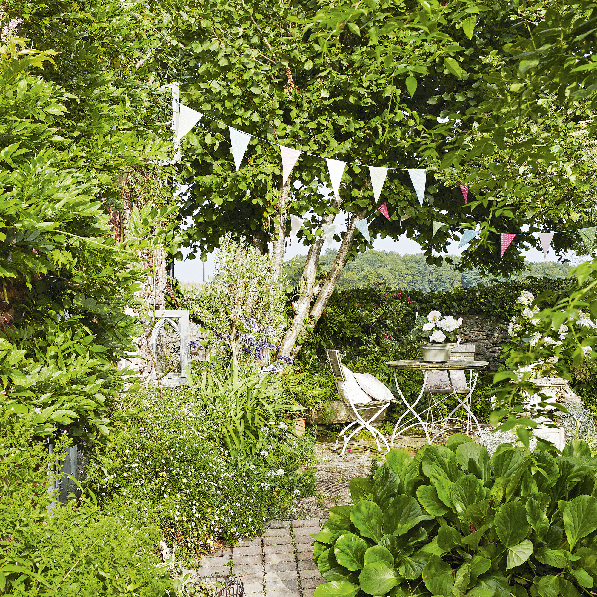 garden with greenery and shrubs and white bunting